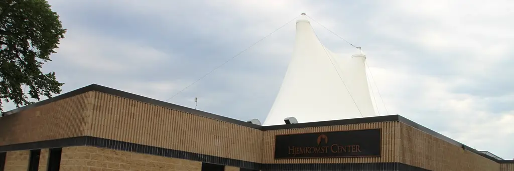 The white sail-shaped roof of the Hjemkomst Center in Moorhead rising above the museum entrance